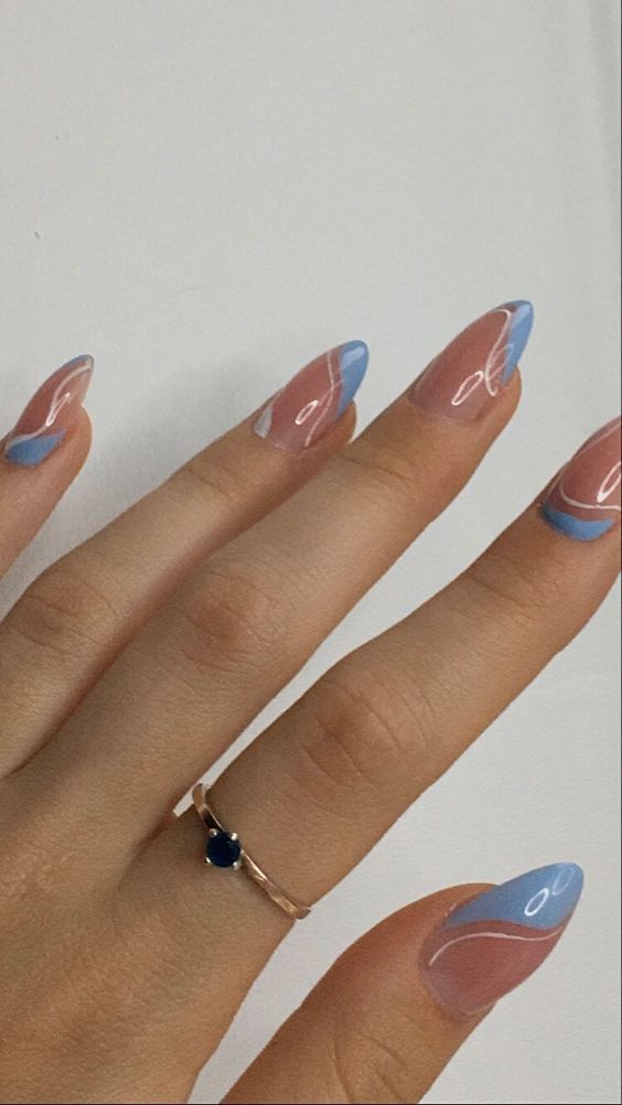 Pastel blue wave design on almond nails