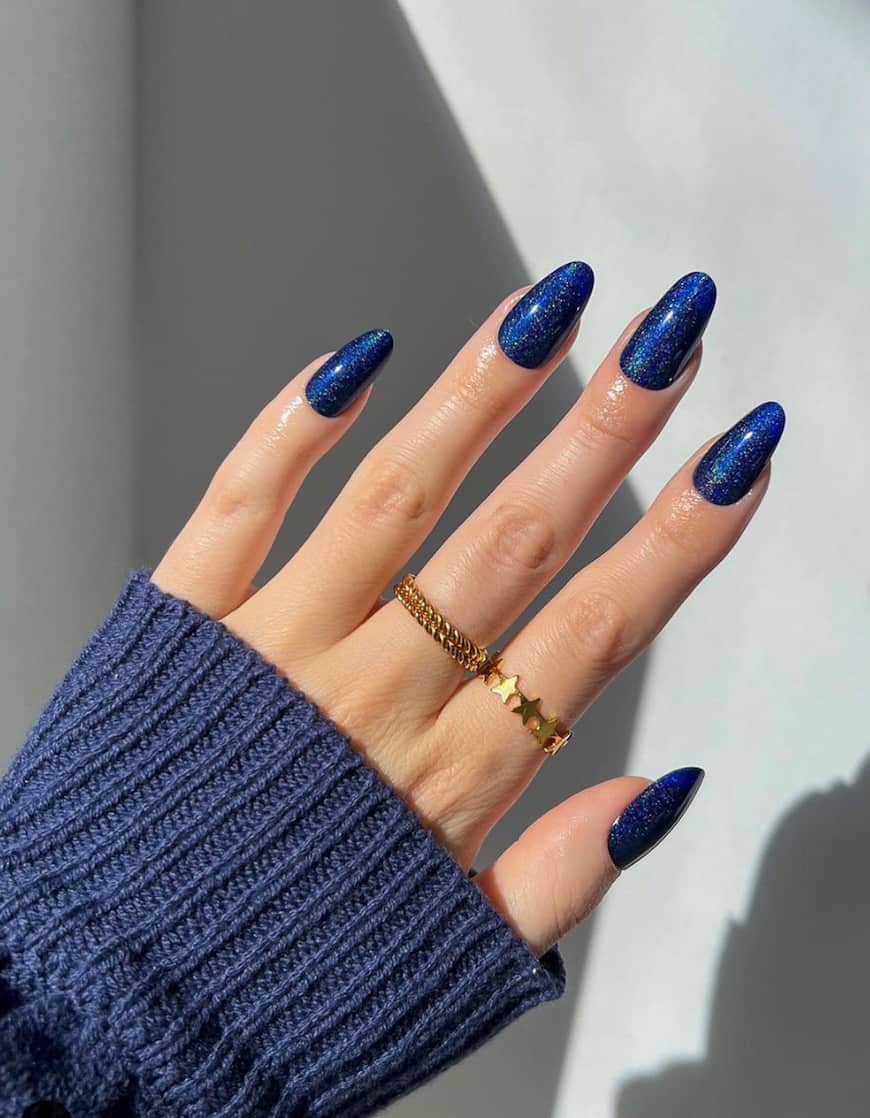 Glittery midnight blue on oval nails