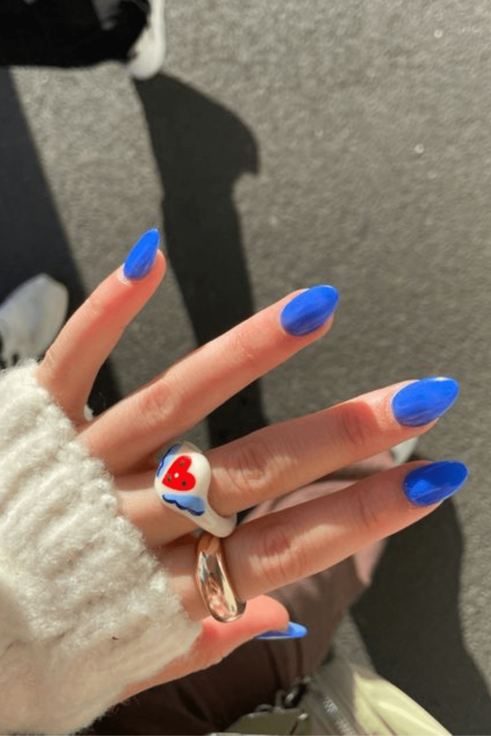 Bright blue almond nails with glossy finish