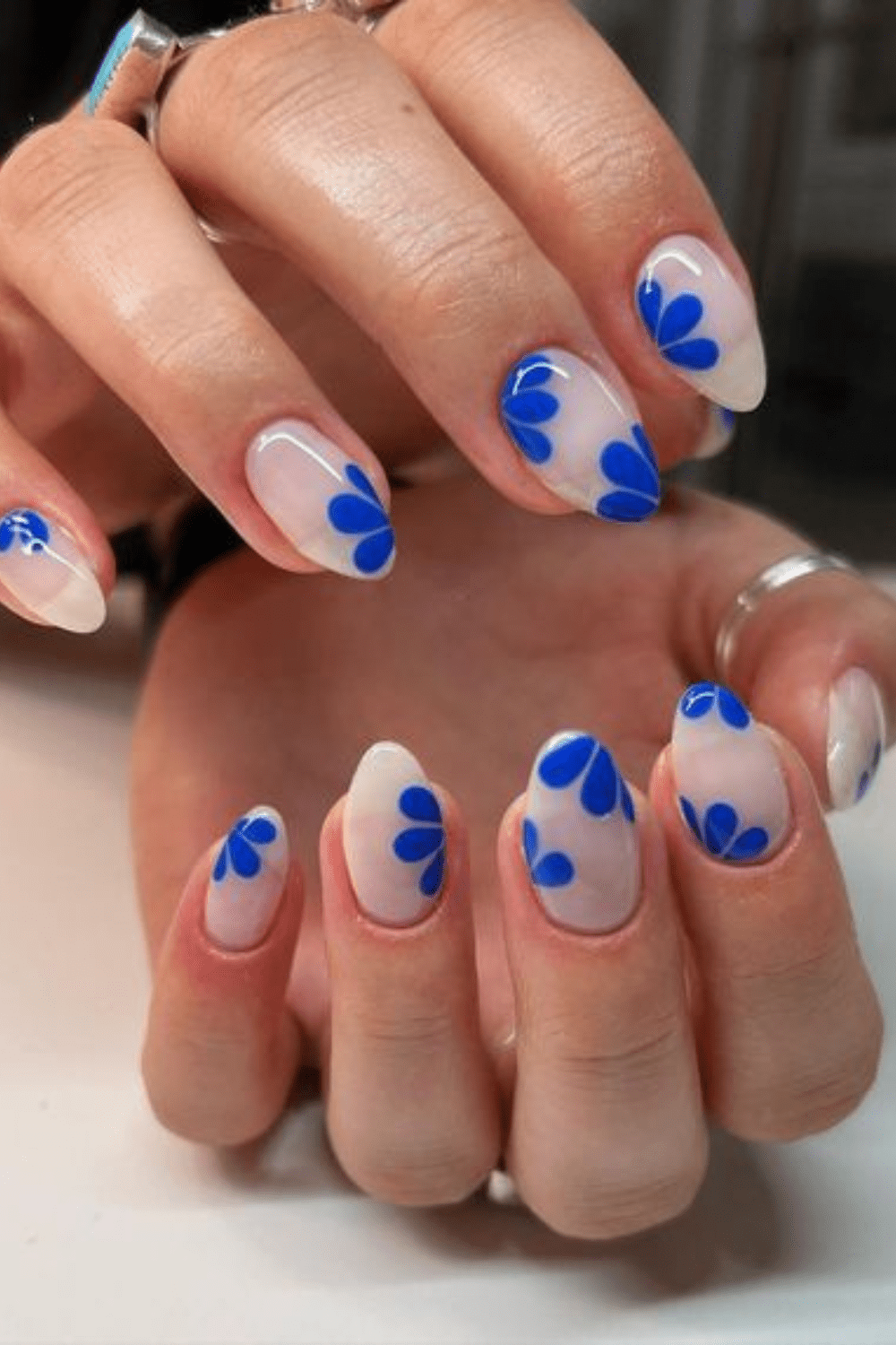 Bold blue petal nail design with clear base