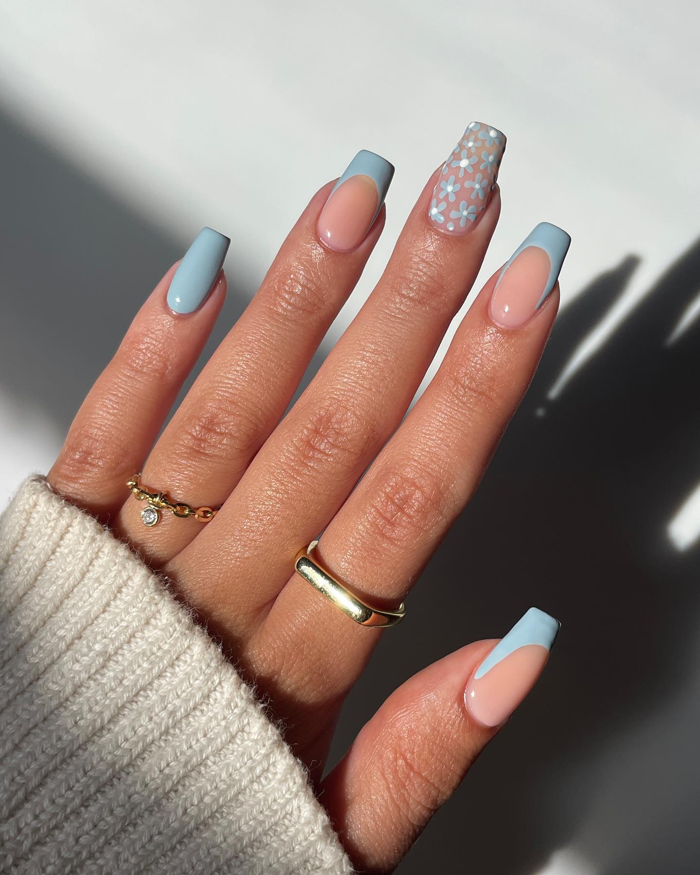 Chic blue accent nail design with modern elements
