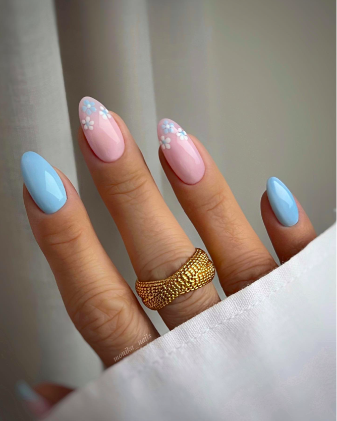 Delicate blue floral nail art with pastel accents