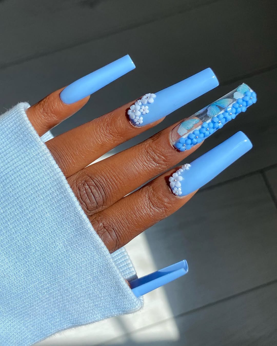 Bold blue nails with intricate details on long length
