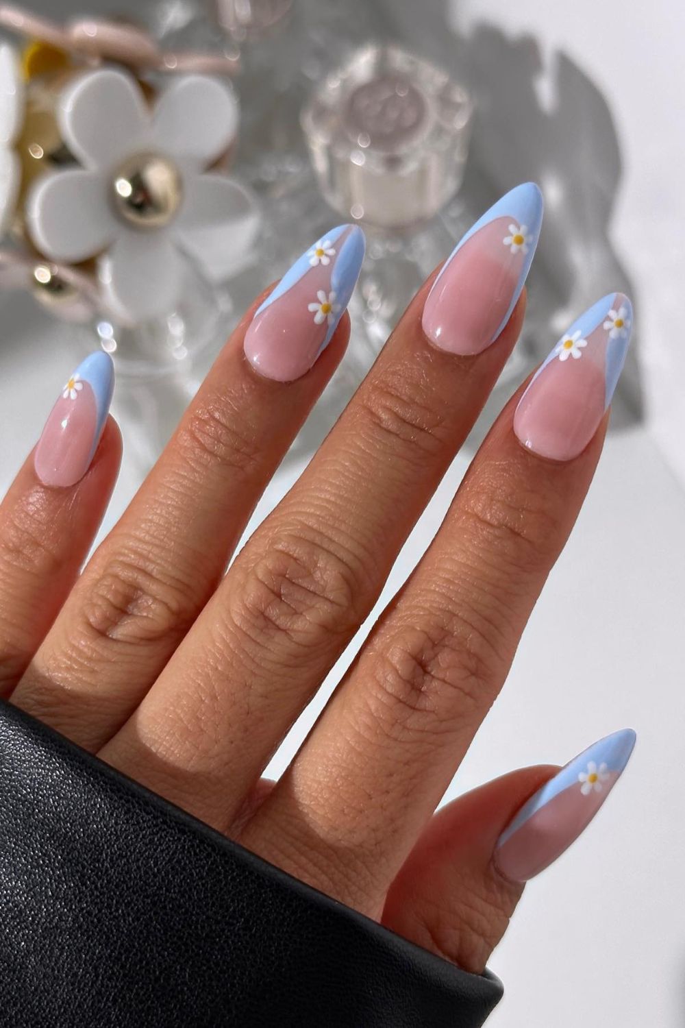 Daisy-tipped blue French manicure on almond nails