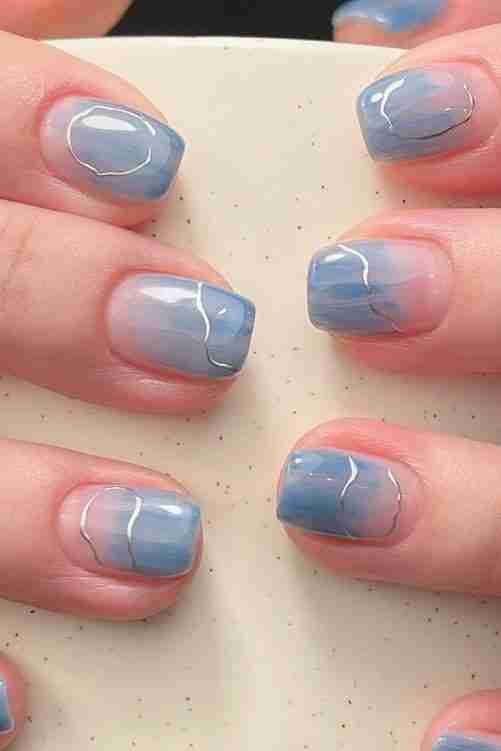 Marble blue nail art with glossy finish on short square nails