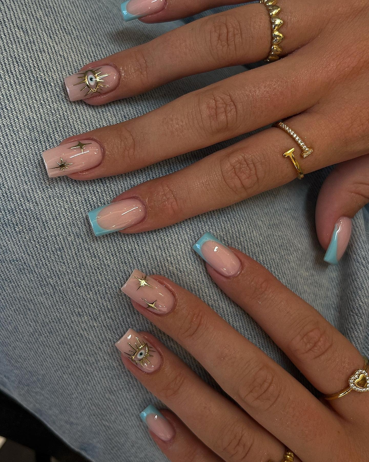 Celestial blue nail art with star accents on square nails
