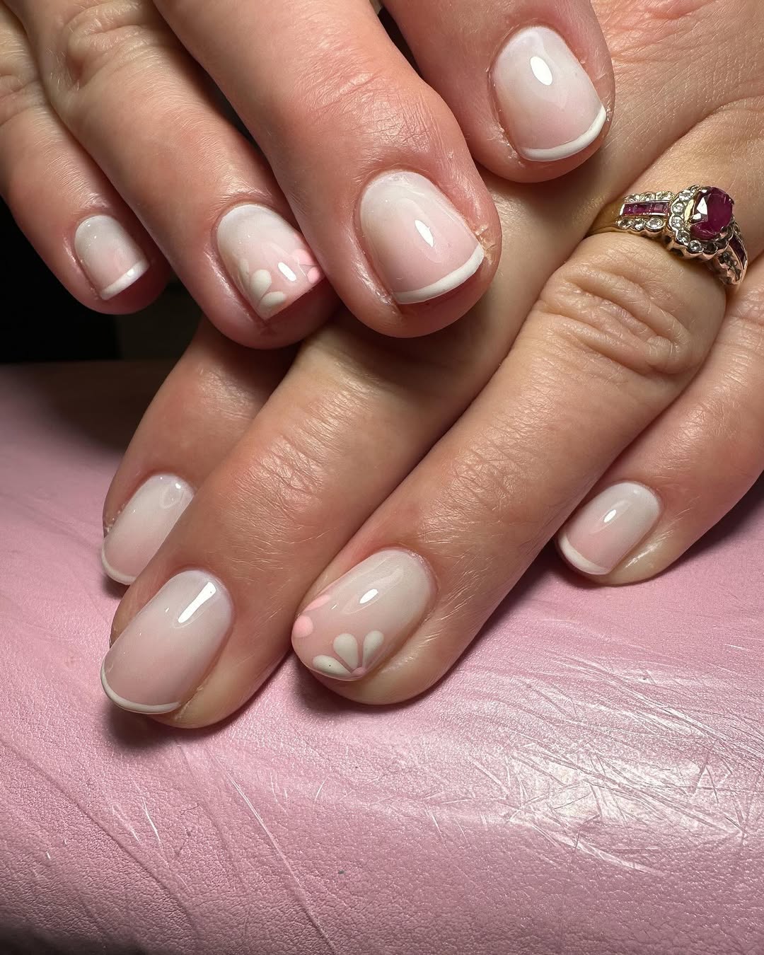 Petal-accented French manicure on short round nails