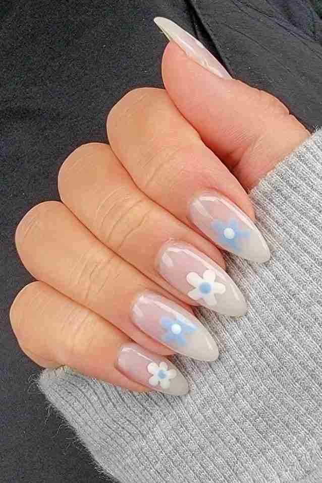 Translucent nails with floral accents on long stiletto shape