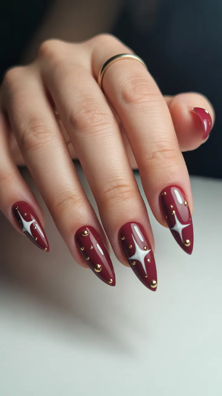 Burgundy nails with studs and celestial design