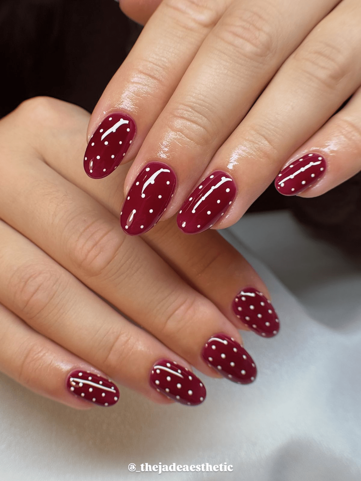 Burgundy nails with white polka dots