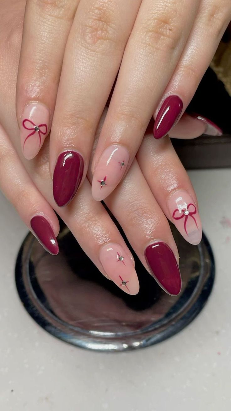 Burgundy nails with pink accents and bows