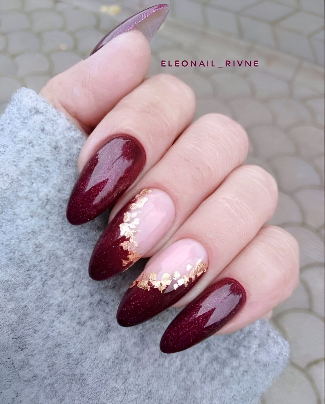Burgundy nails with gold leaf accents