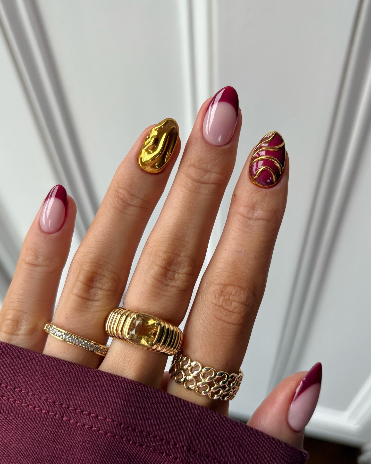 Burgundy and gold abstract almond nails