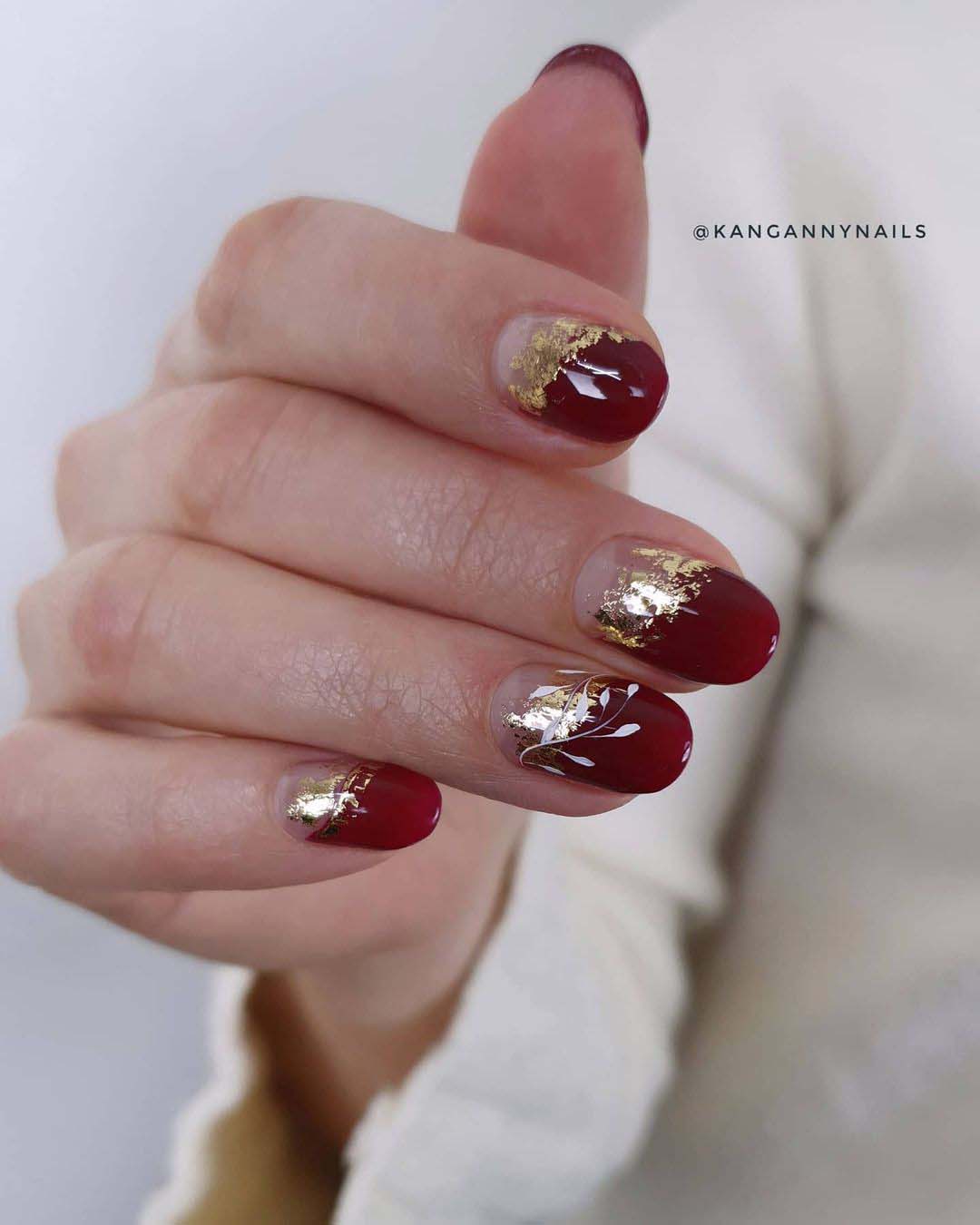 Burgundy nails with gold foil accents