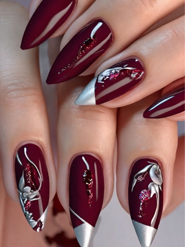 Burgundy nails with silver floral design and embellishments