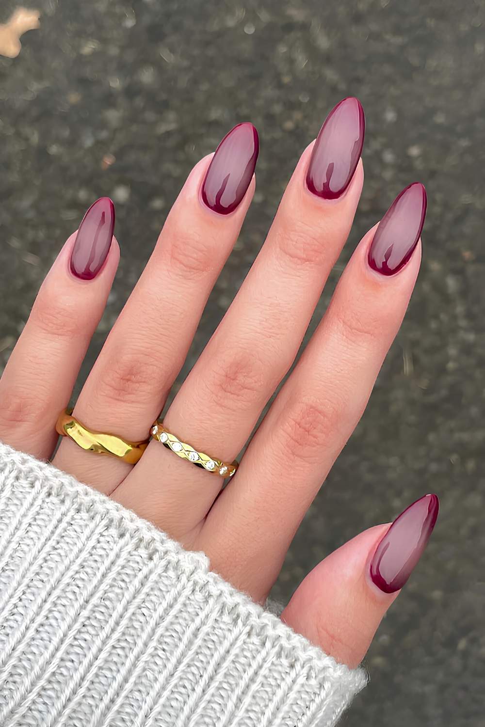 Sheer burgundy almond nails with glossy finish
