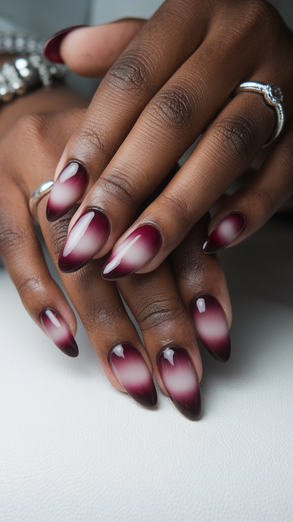 Ombre burgundy nails with glossy finish on almond shape
