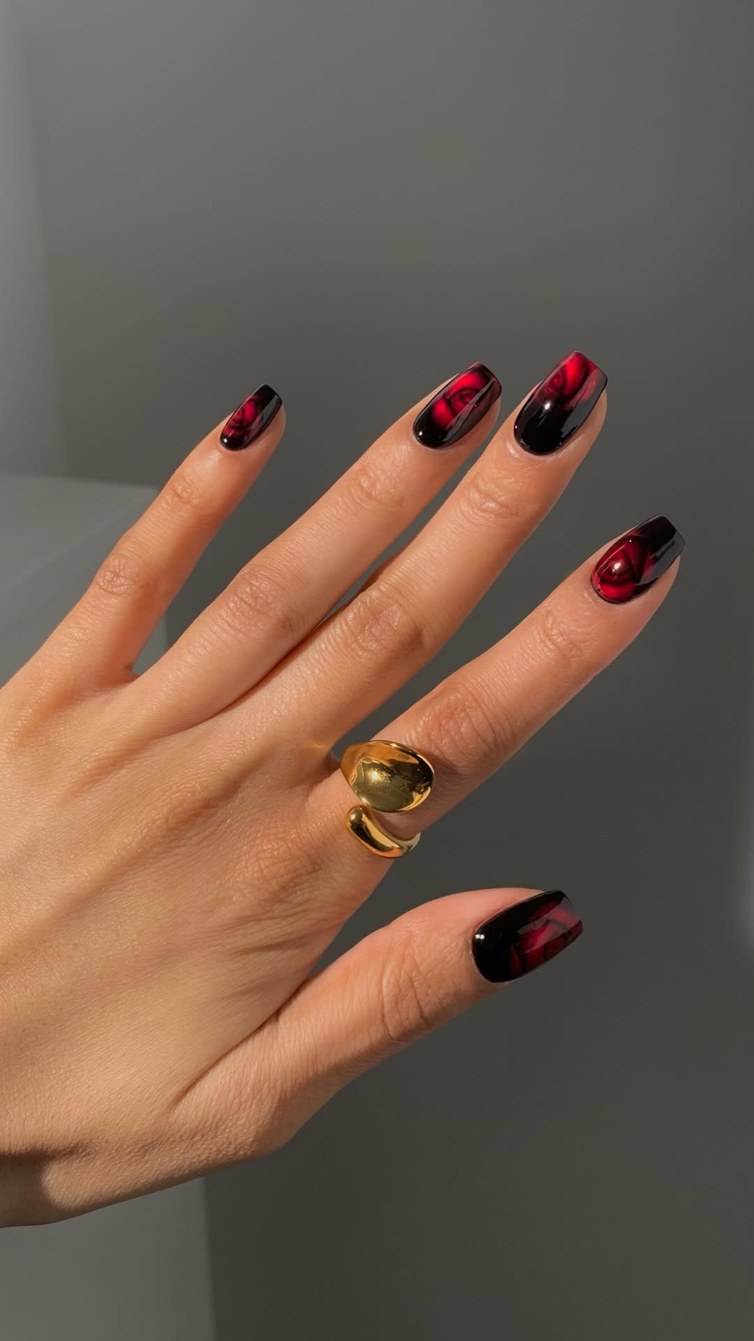 Cherry red marble nails with black accents