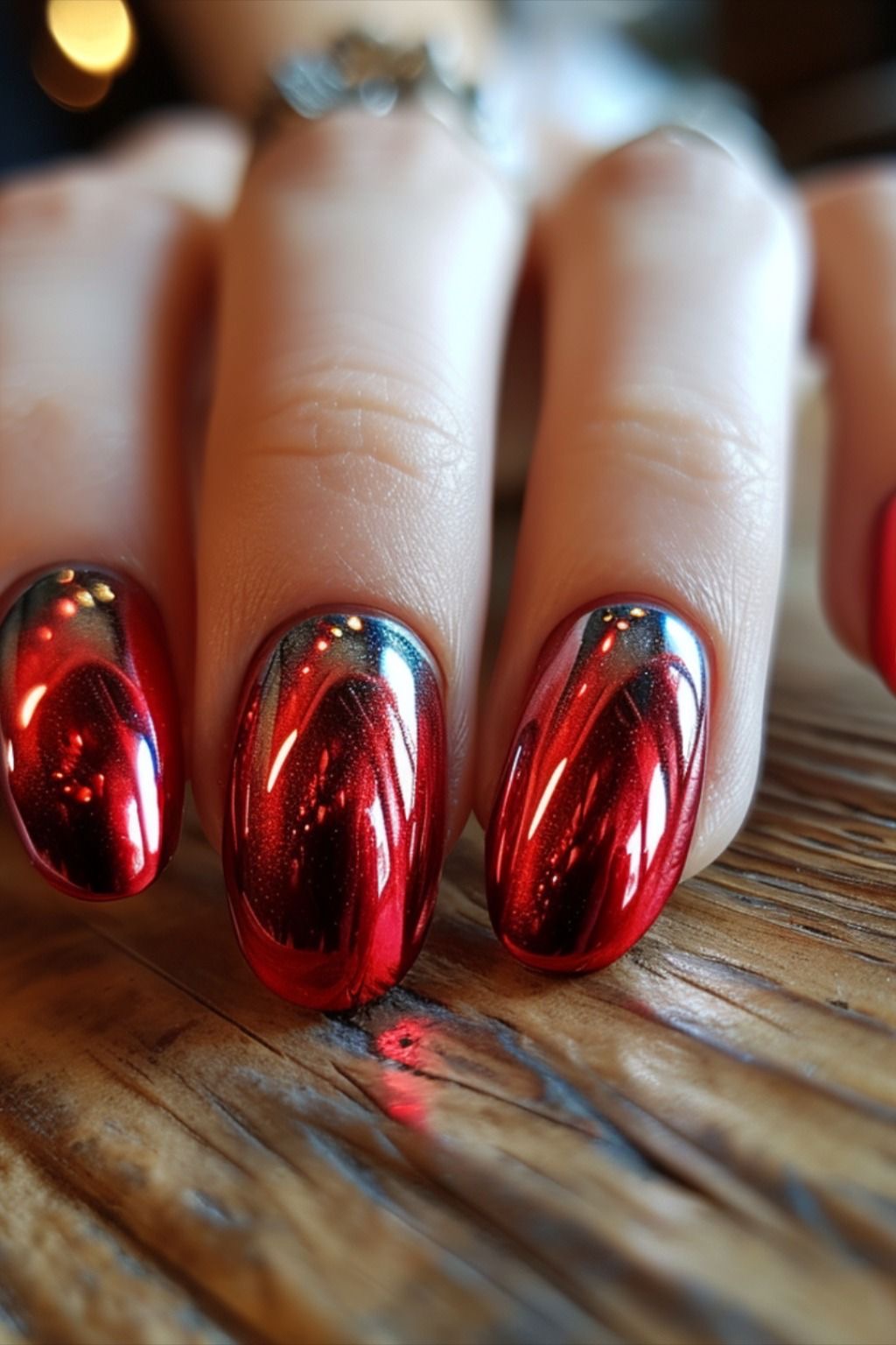 Chrome cherry red nails with a mirror finish