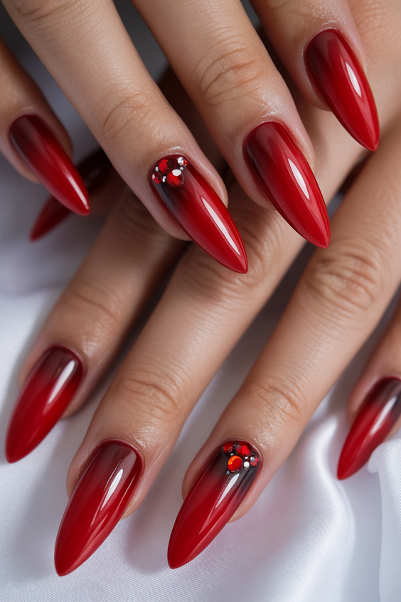 Cherry red nails with gemstone accents