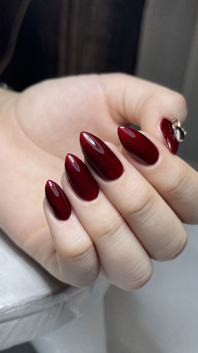Deep cherry almond nails with glossy finish