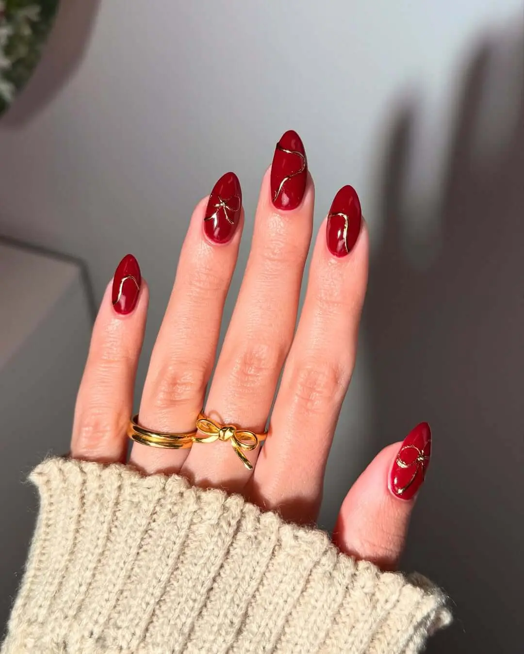 Rich red almond nails with gold accents, Pinterest nail art, elegant design