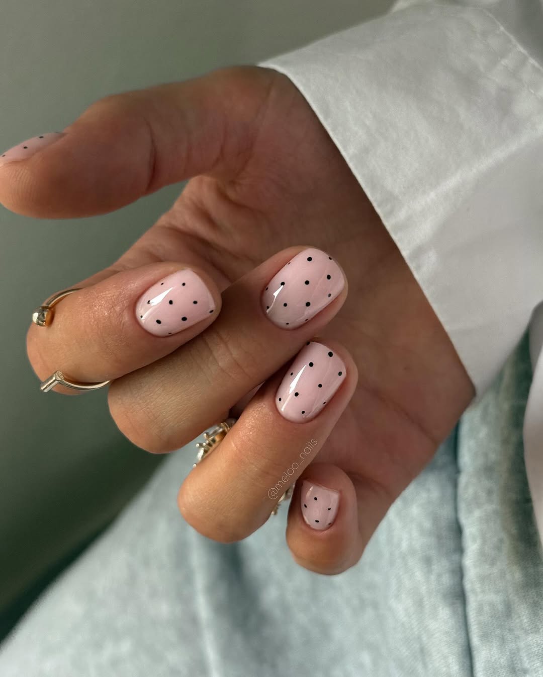 Subtle polka dot pattern on nude nails.