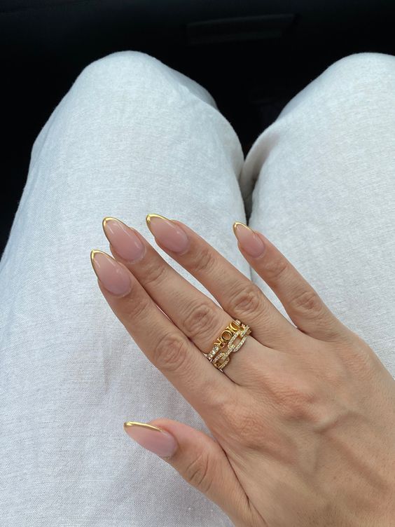 Gold-tipped almond nails, elegant and chic.