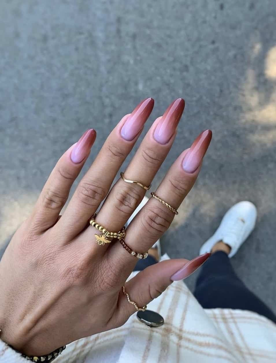 Gradient burgundy on almond nails.