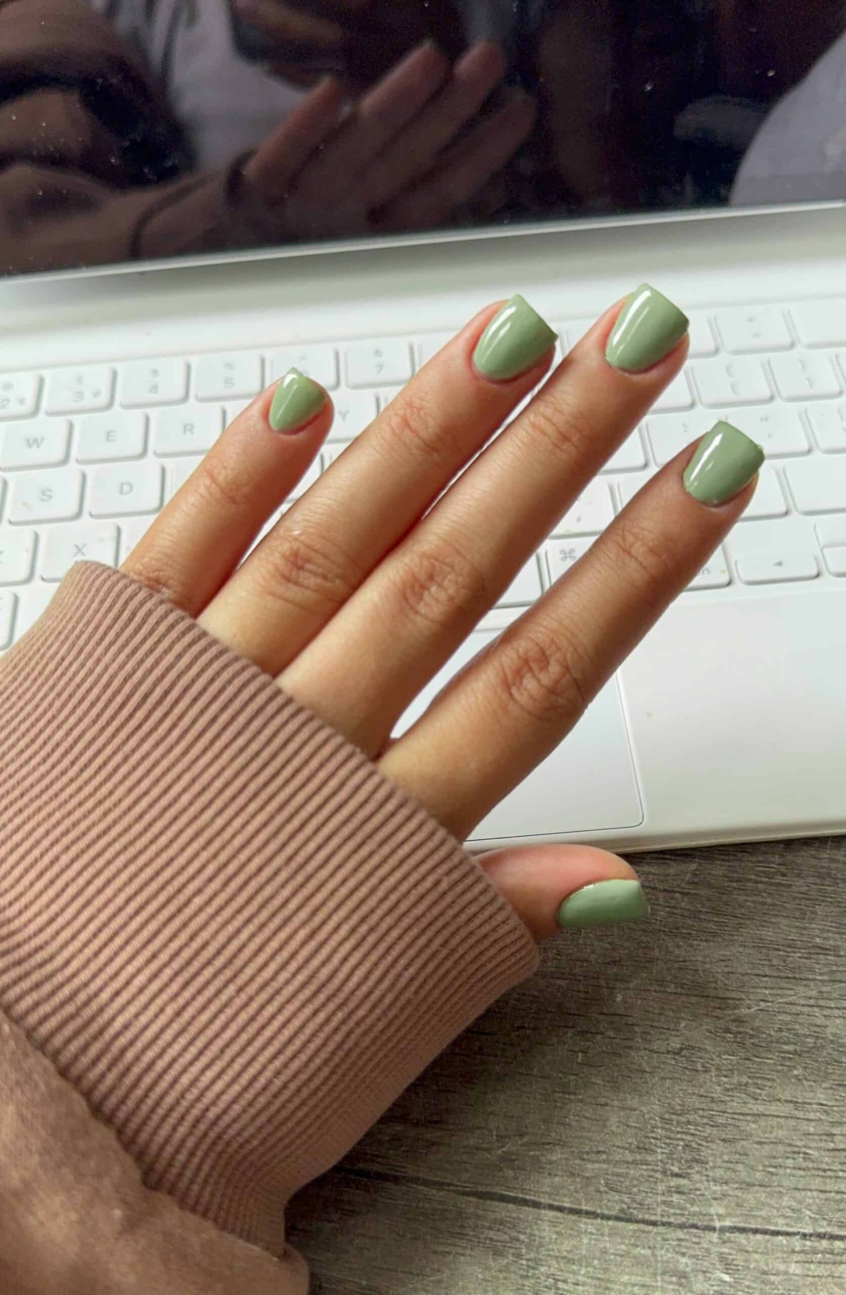 Muted sage short square nails, elegant style.
