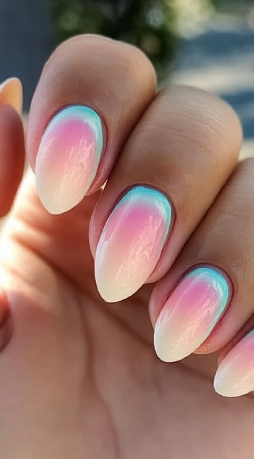 Pastel ombre nails with a soft glow.