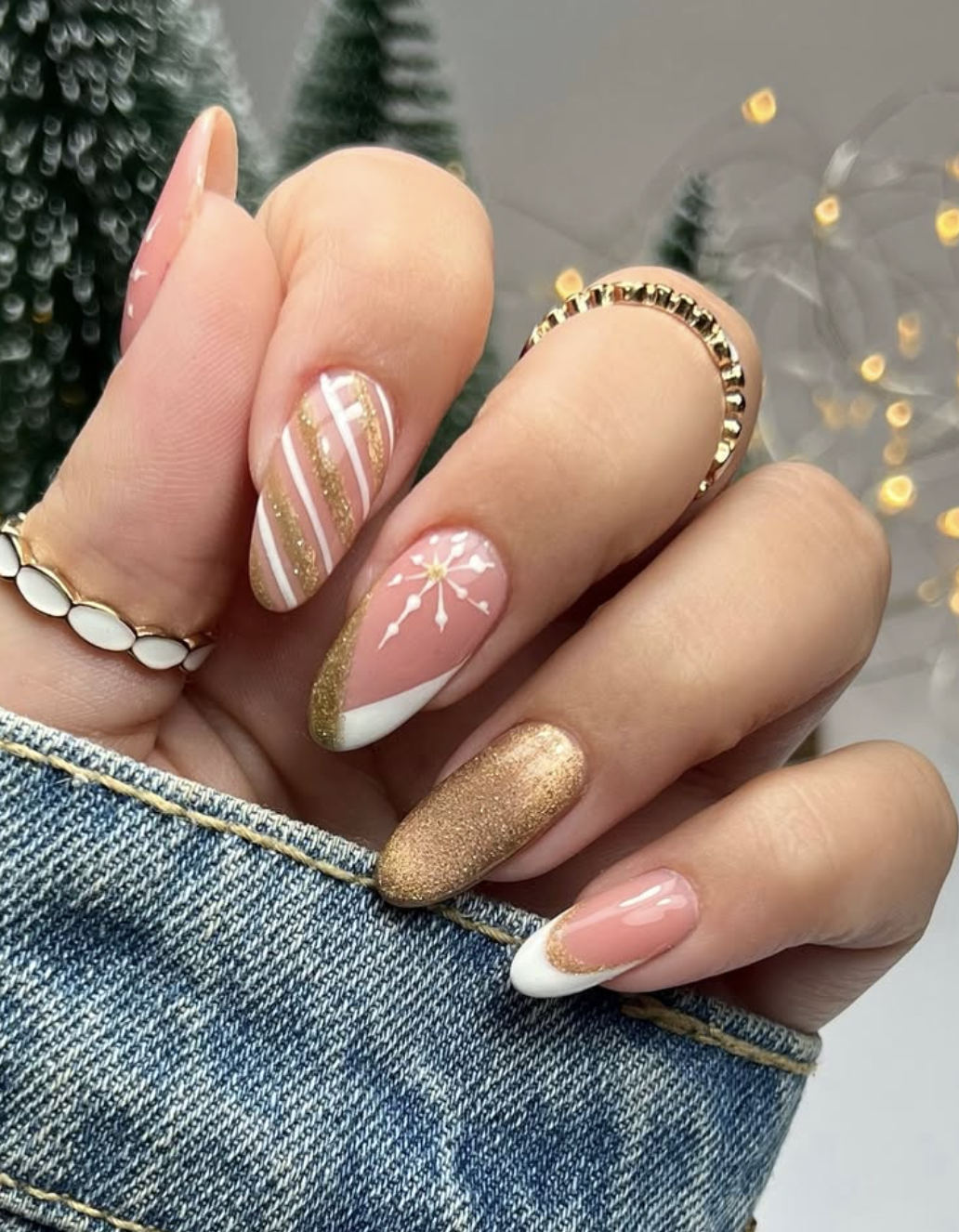 Blush nails with gold accents.