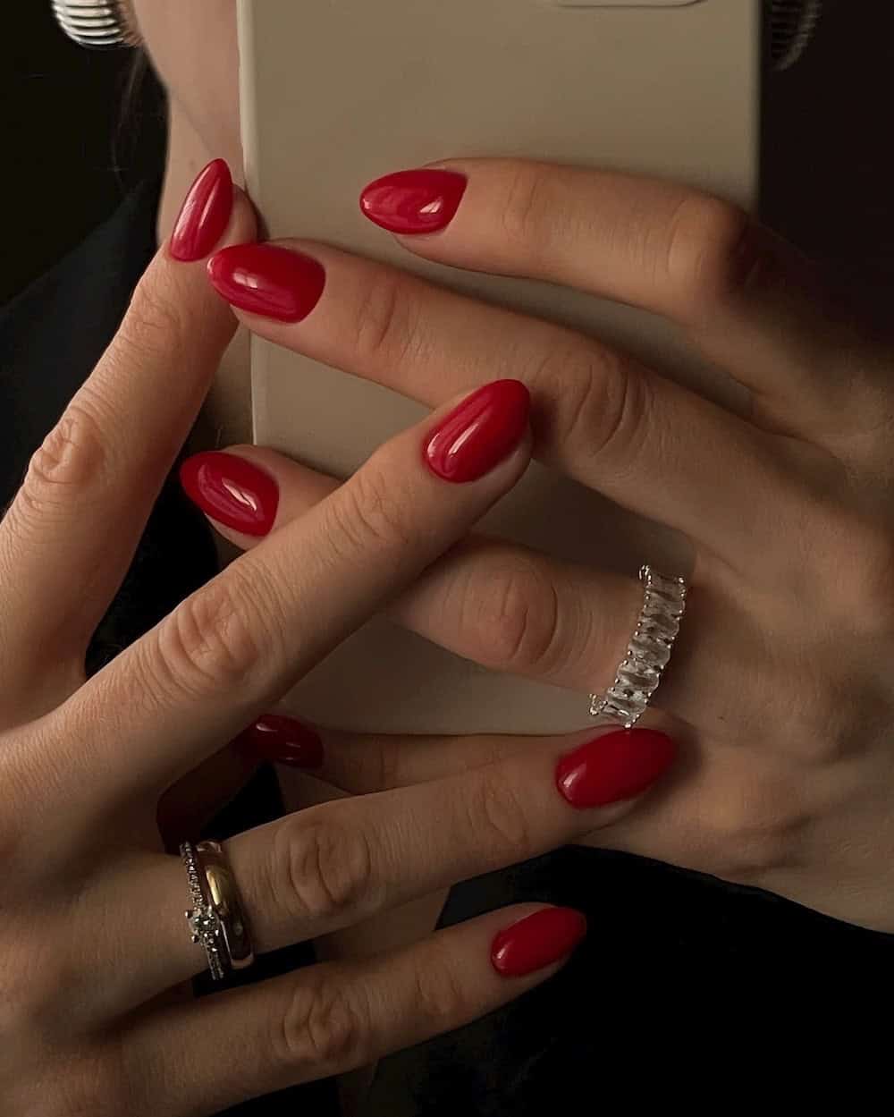 Classic red glossy manicure on almond nails