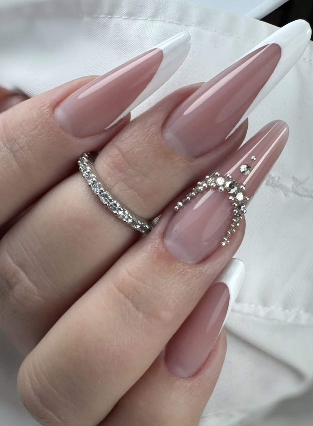 Embellished nude French nails with rhinestones