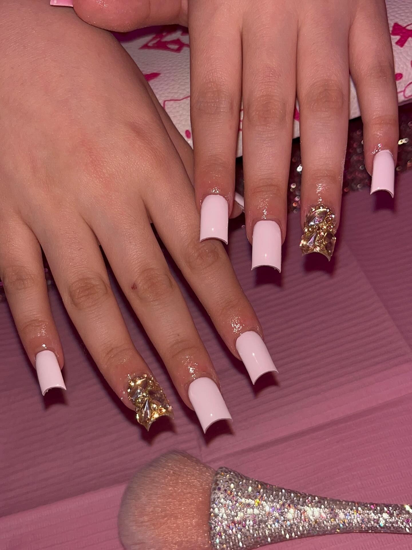 Square-shaped nails with embellished pink French tips, showcasing trendy and glamorous nail art designs.