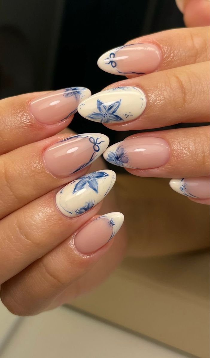 Almond-shaped nails with blue floral French tips, delicate and artistic.