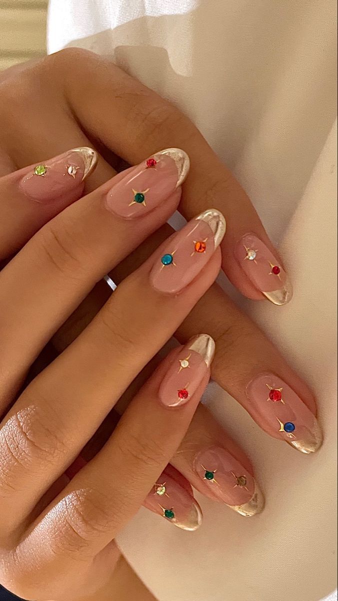 Almond-shaped nails with gem-studded French tips, luxurious and colorful.