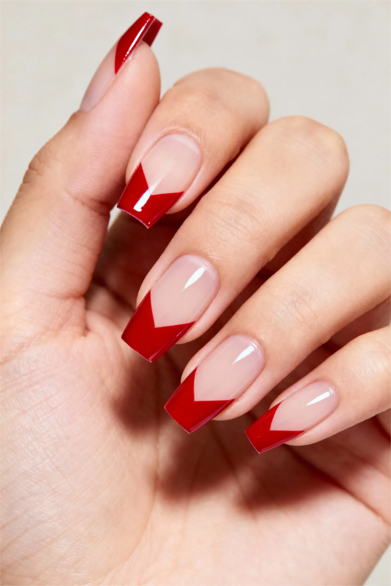 Square nails with red chevron French tips, bold and modern.