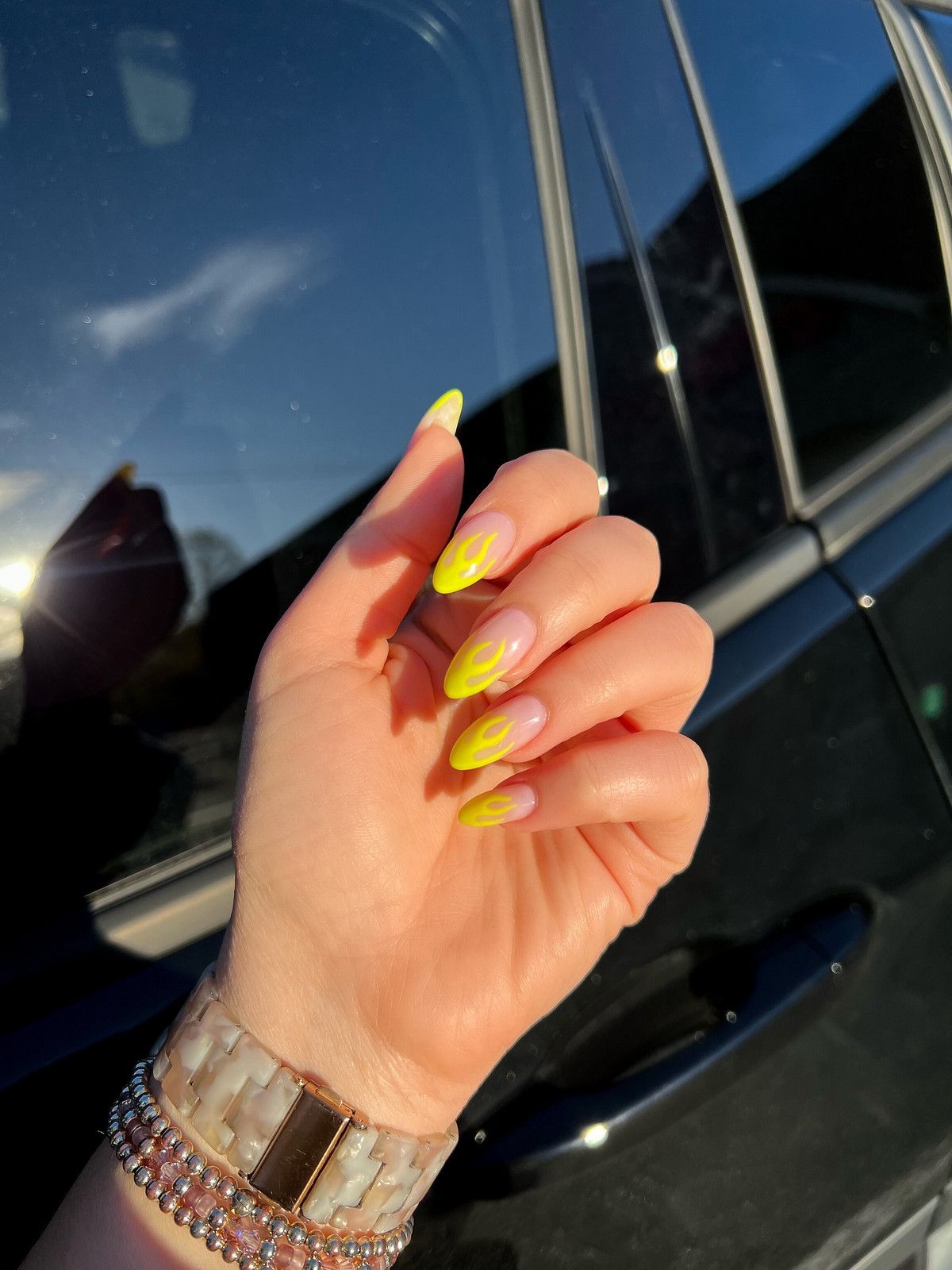 Almond-shaped nails with neon yellow French tips, lively and bright.