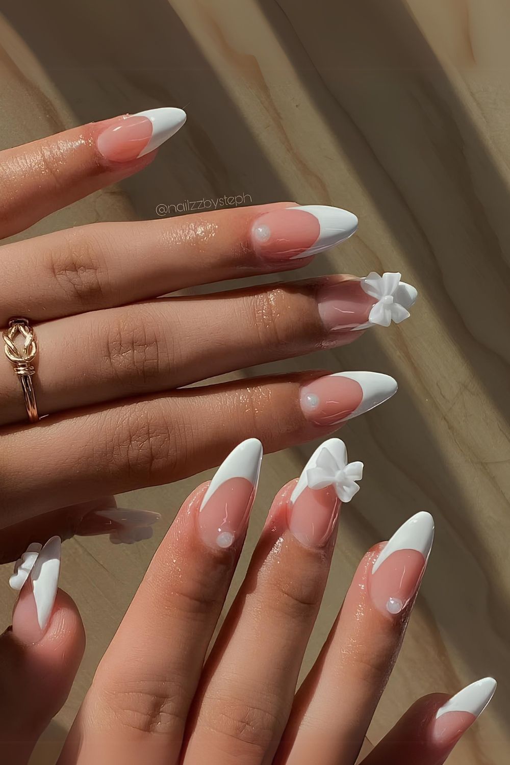 Almond nails with white pearl French tips, elegant and sophisticated.