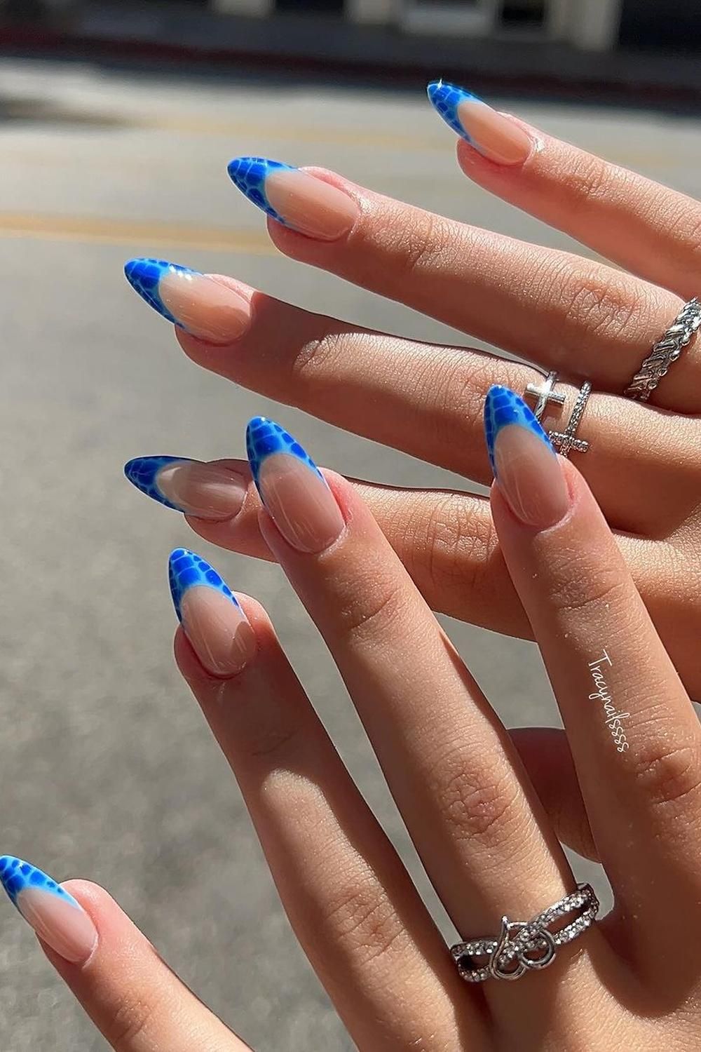 Almond nails with blue giraffe print French tips, bold and creative.