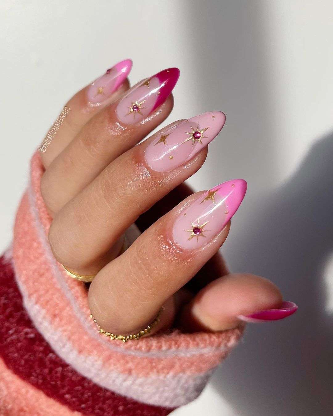 Pink ombré nails with gold stars, celestial and romantic.