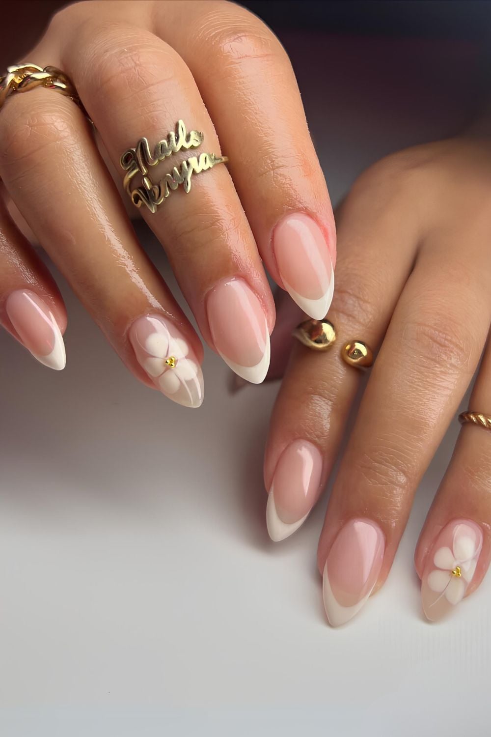 French tips with floral accents, timeless and refreshing.