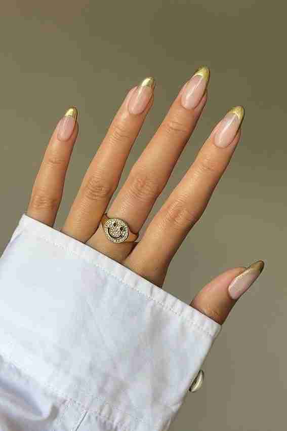 Golden French tips with nude base, chic and modern.