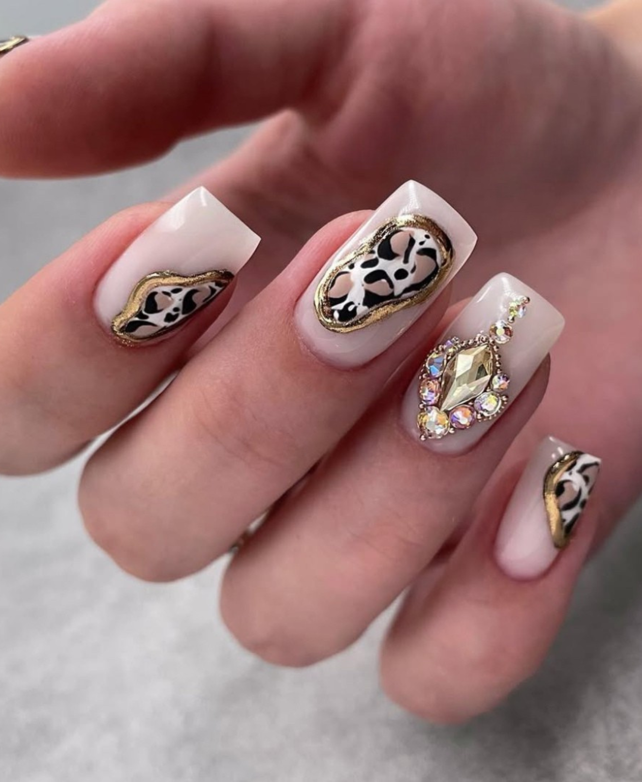 Leopard print nails with jewels, bold and luxurious.