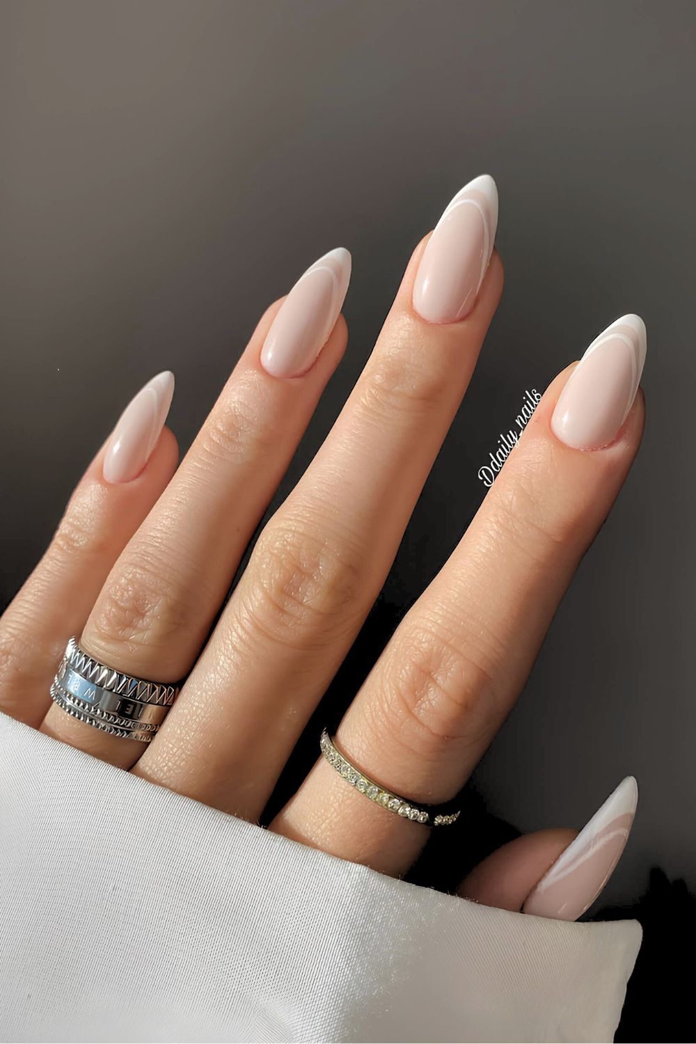 Soft almond nails with French tips, elegant and refined.
