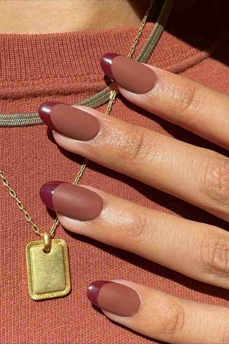 Matte burgundy French tips on almond nails, chic and sophisticated.