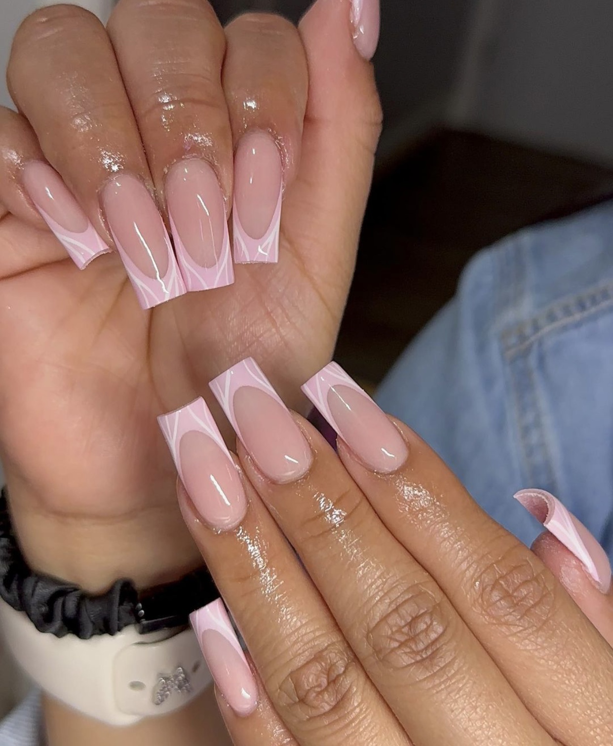 Geometric pink and white French tips on coffin nails, elegant and trendy.