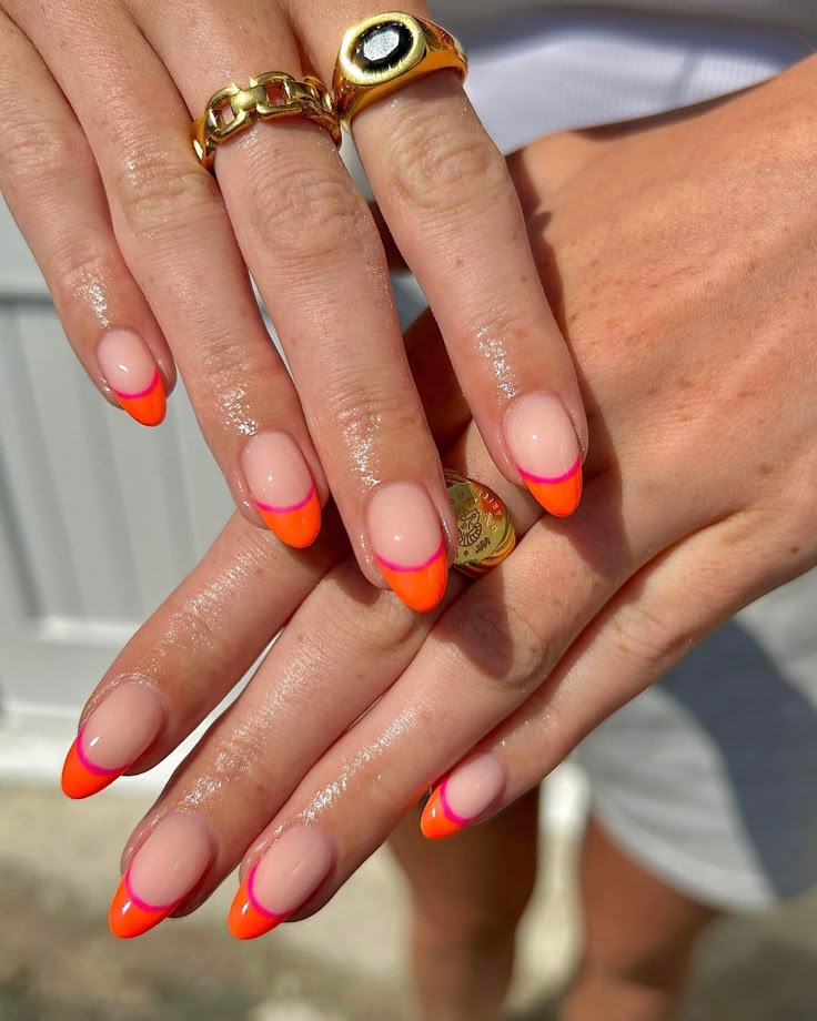 Neon gradient French tips with orange and pink, perfect for summer parties