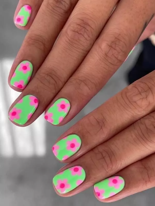Neon floral designs on short nails, vibrant and playful